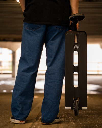 CORE ST2 Stunt Scooter Black I Adult Stunt Scooter Holding Skatepark