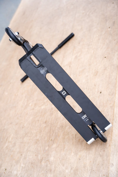 CORE ST2 Stunt Scooter Black & Raw I Adult Stunt Scooter Alternate Leaning Bottom